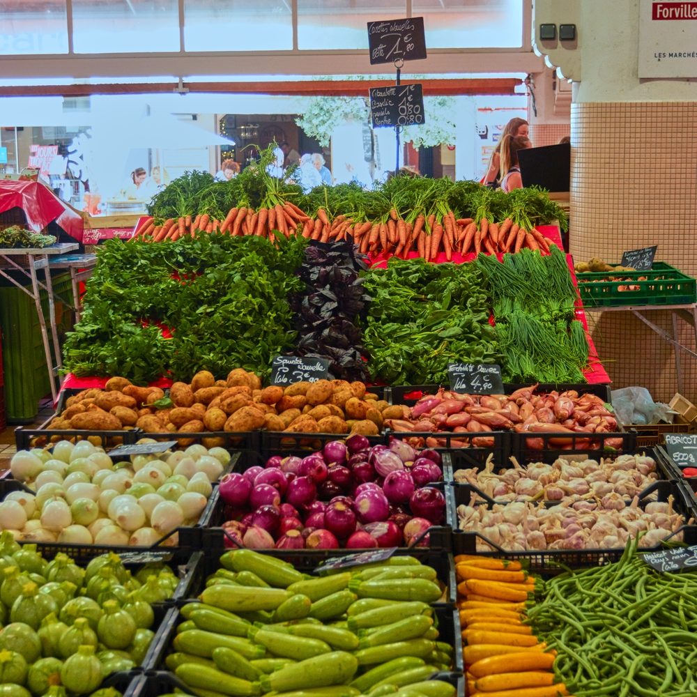 A vertical shot of the bazaar full of different vegetables